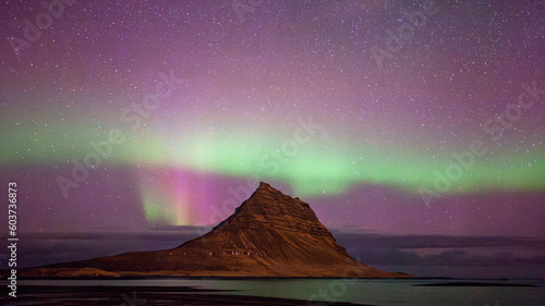 Pink and green Northern Lights with Kirkjufell Mountain  Iceland