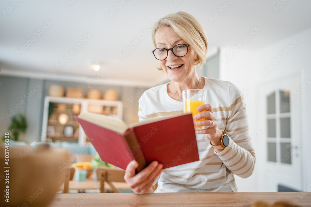 Senior woman mature caucasian female read book at home wear eyeglasses Senior woman mature caucasian female read book at home wear eyeglasses