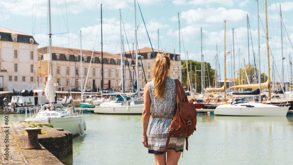 Woman visiting Rochefort city and port, Charente Maritime,  Nouvelle aquitaine in France - obrazy, fototapety, plakaty 