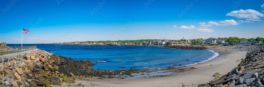 View of the sea from the beach. Seascape with American Flag waving at Back Habor of Sandy Bay in Rockport, Cape Anne, Massachusetts