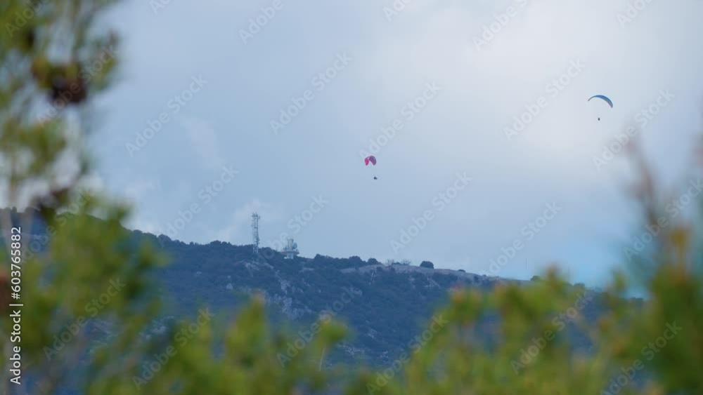 Paragliding in Monaco. Two paragliders which fly over the mountains of the French Riviera Paragliding in Monaco. Two paragliders which fly over the mountains of the French Riviera