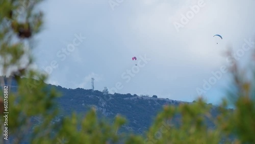 Paragliding in Monaco. Two paragliders which fly over the mountains of the French Riviera