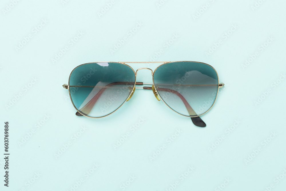 Sunglasses on color background, top view. Sunglasses on color background, top view.