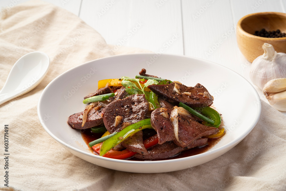 Stir Fried Pork Liver and Sweet Pepper with Black Peppercorn in white plate
