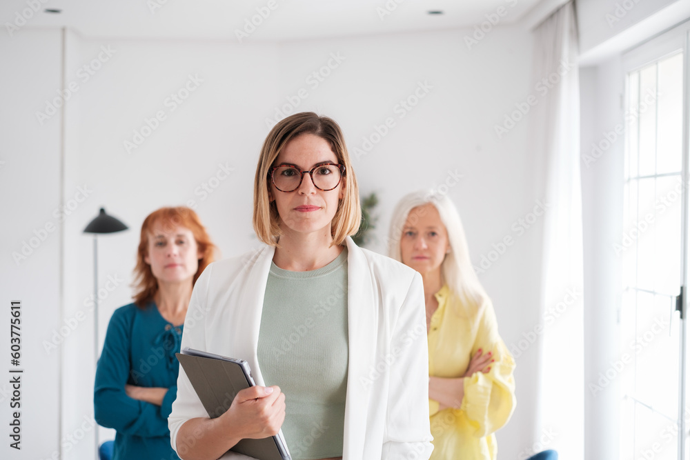 Fototapeta premium Three businesswomen together in the management team photos in the office. Concept: business, entrepreneur, investment