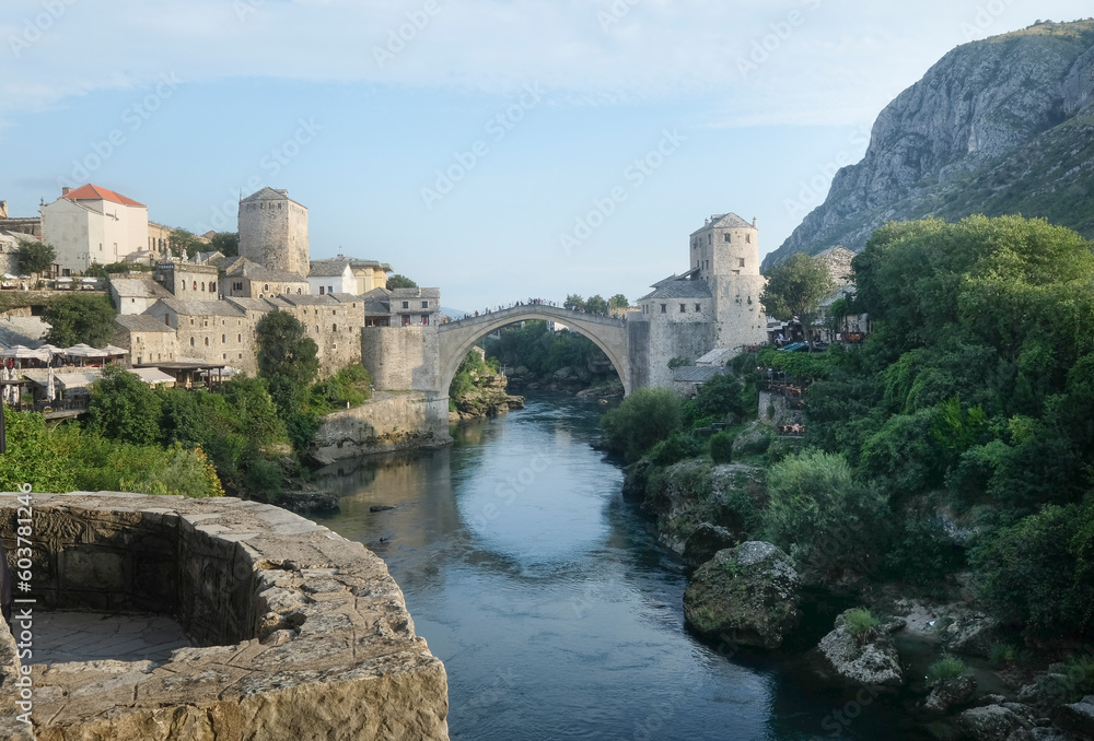 Skyline of Mostar with the Mostar Bridge, houses and minarets, at the sunset in Bosnia and Herzegovina.