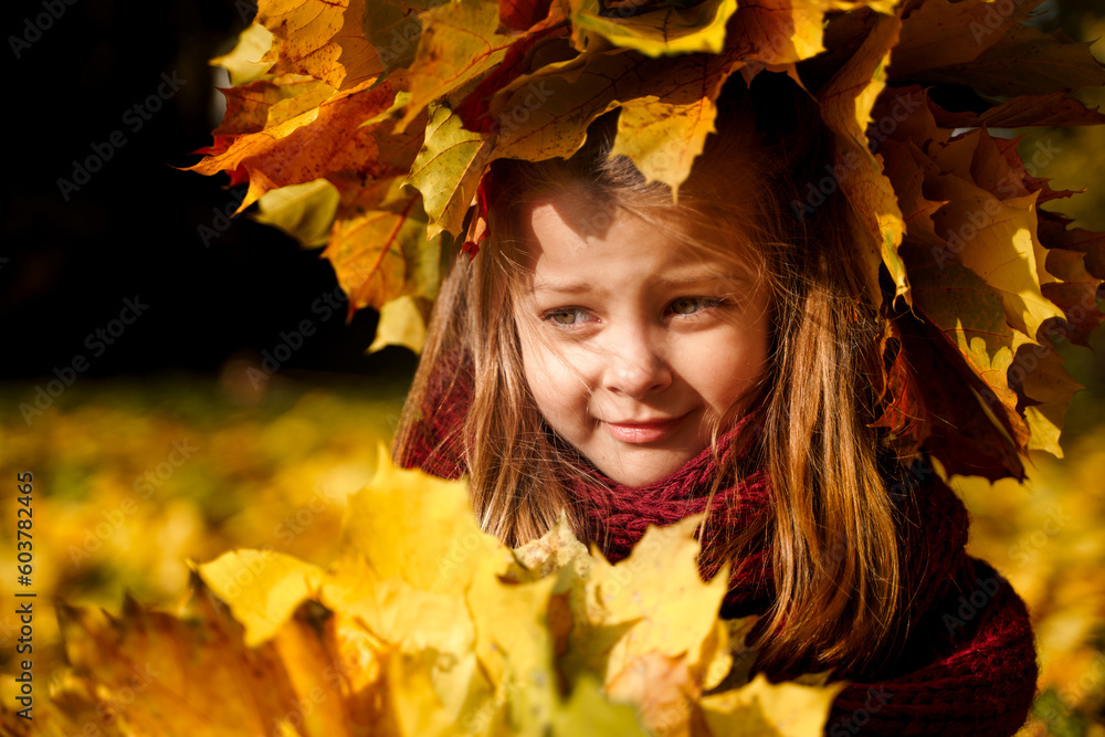 Beautiful little girl in bright yellow orange autumn warm knitted hat and scarf snood with bouquet of maple leaves,foliage walking in forest. Fun playing in park. Outdoor family activity in nature Beautiful little girl in bright yellow orange autumn warm knitted hat and scarf snood with bouquet of maple leaves,foliage walking in forest. Fun playing in park. Outdoor family activity in nature