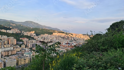 Genoa, Italy - May 6, 2023: Top view of the city of Genoa at sunset from the mountains. Aerial view of Genoa and Sampdoria soccer teams stadium in Genoa Marassi in Italy.
