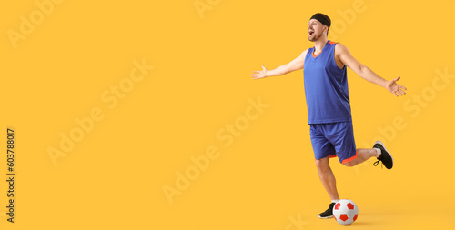 Emotional soccer player with ball on yellow background with space for text