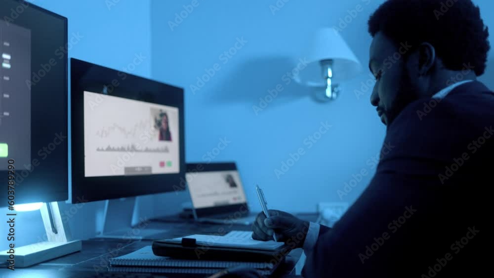 Business African trader investor making stock market analysis video call inside office at night - Financial broker economic concept Business African trader investor making stock market analysis video call inside office at night - Financial broker economic concept
