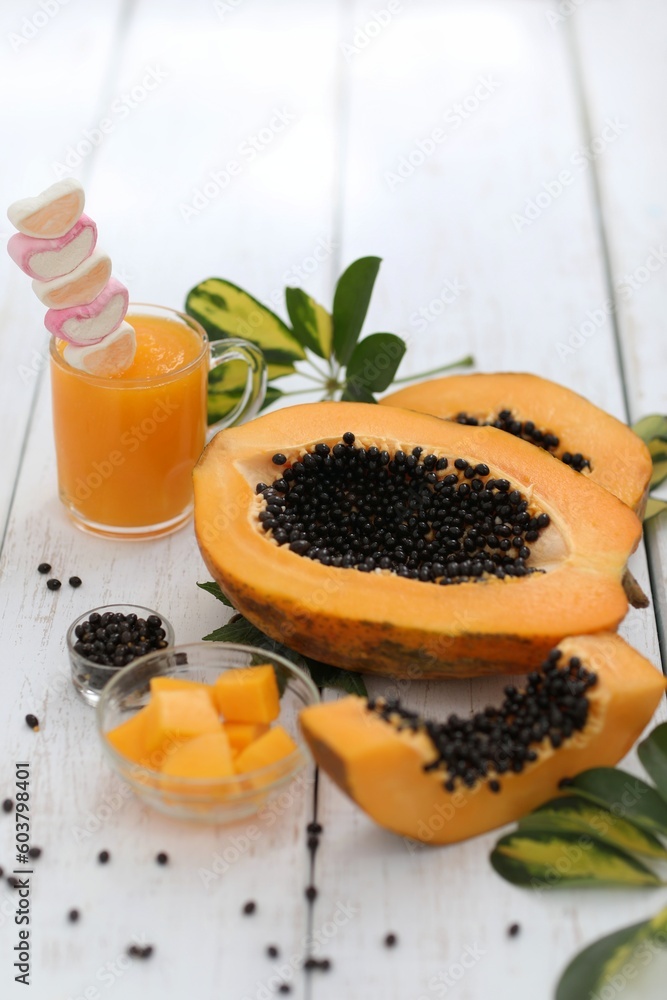 Papaya smoothie, juice, puree, papaya cut into pieces, on a white wooden table, exotic fruit, tropical plant, healthy food, breadfruit, black seeds, background, wallpaper for presentations Papaya smoothie, juice, puree, papaya cut into pieces, on a white wooden table, exotic fruit, tropical plant, healthy food, breadfruit, black seeds, background, wallpaper for presentations