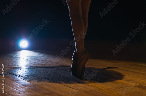 Closeup of Ballerina Legs in Dark Theater on Fingertips. Beautif