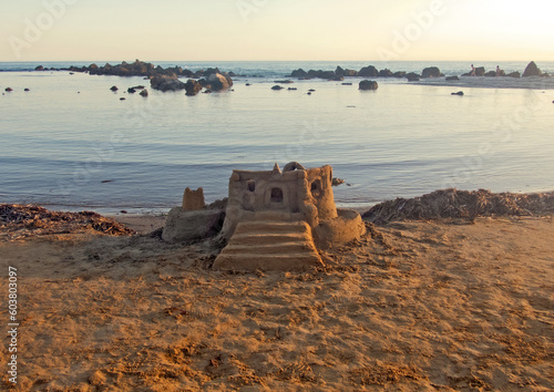 Castello di sabbia sulla spiaggia al tramonto, Realmonte, Sicilia photo
