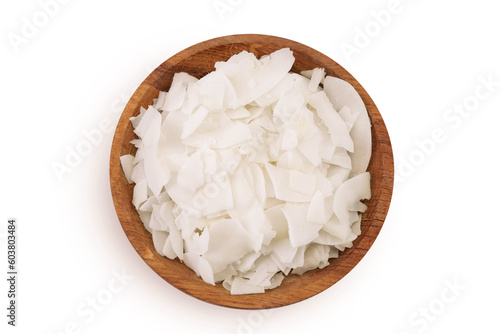 Coconut flakes or chips in wooden bowl isolated on white background. Top view. Flat lay