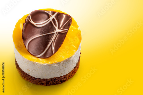 Yellow glazed cheese cake with chocolate decoration. Exquisite Fresh delicious dessert. photo