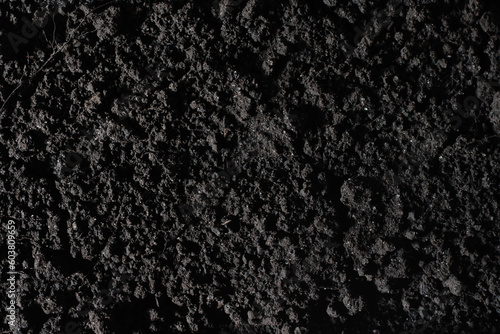 Fertile black soil texture top view background