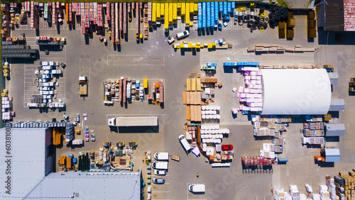 Aerial view of building materials warehouse. Large storage of construction materials in industrial city zone from above. Background texture concept.
