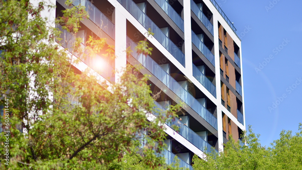 Picture of Foto de Eco architecture. Green tree and new apartment building. The ...