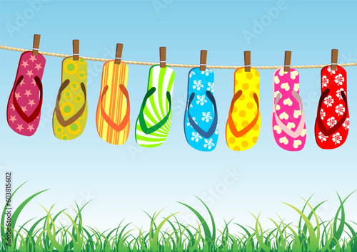 Beach sandals. Different colorful flip-flops hanged on a rope.