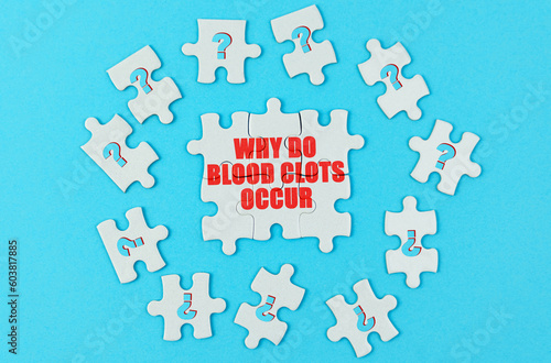 On a blue surface are puzzles with a question mark, in the center with the inscription - why do blood clots occur photo