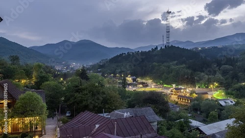Time lapse night view of Dilijan city in Armenia with mountains and moving clouds in background