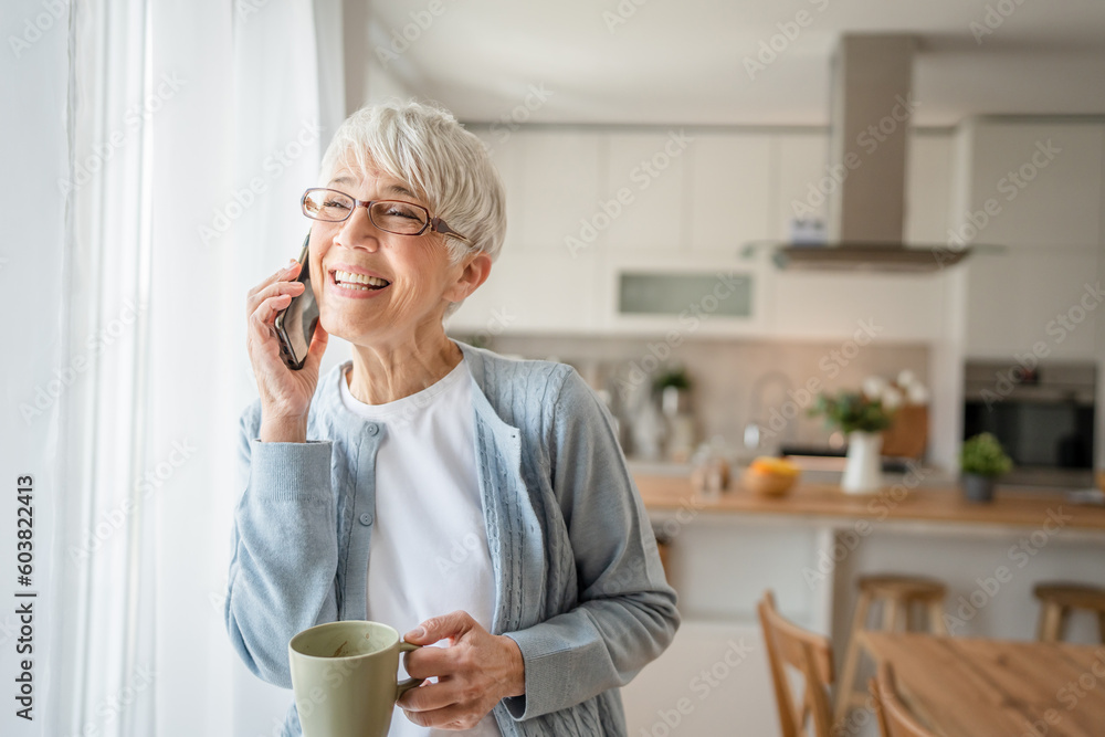 One senior woman with short gray hair use smartphone at home portrait One senior woman with short gray hair use smartphone at home portrait