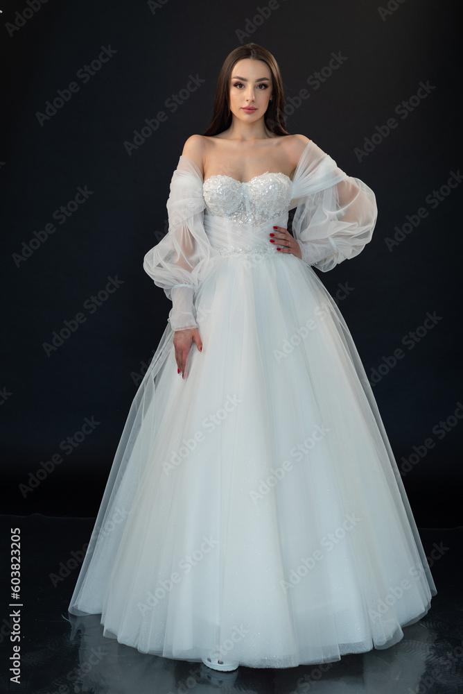 Beautiful bride in wedding dress on black background Beautiful bride in wedding dress on black background