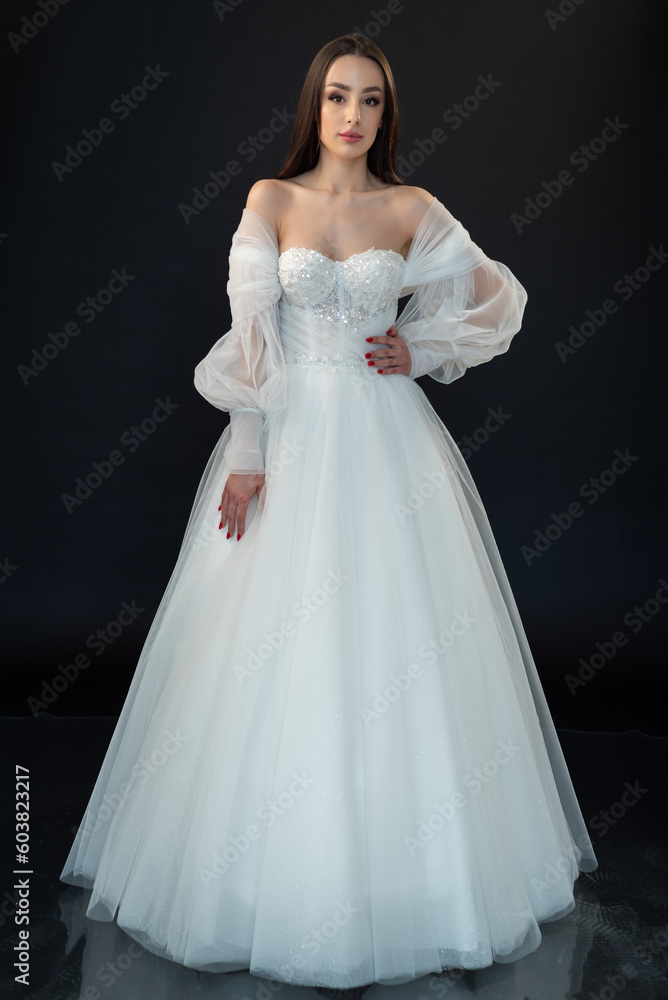 Beautiful bride in wedding dress on black background Beautiful bride in wedding dress on black background