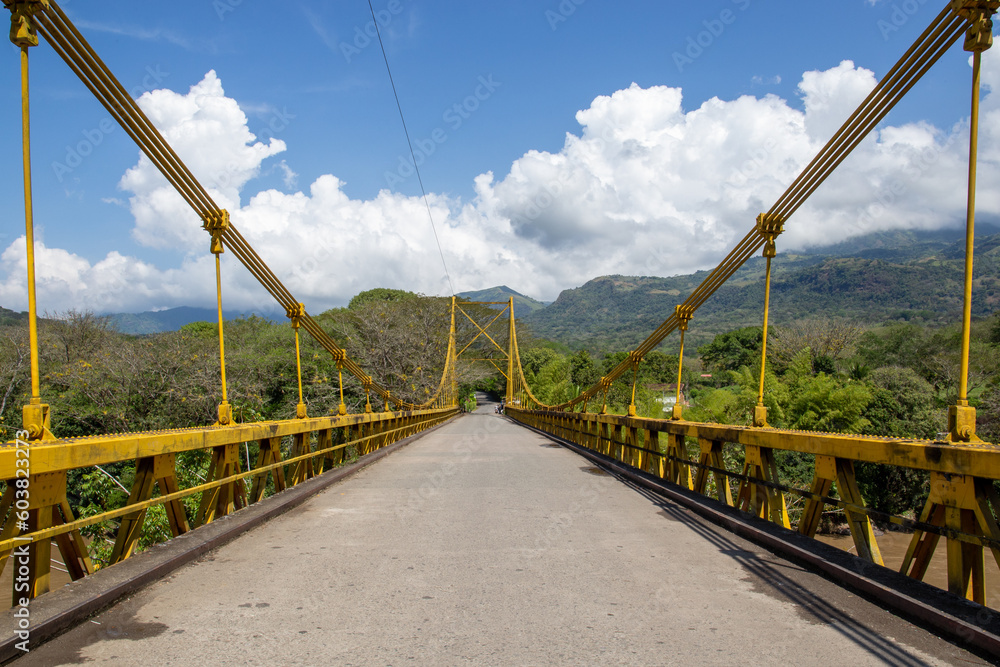 yellow bridge over a river of cloudy water in Colombia in Latin America yellow bridge over a river of cloudy water in Colombia in Latin America