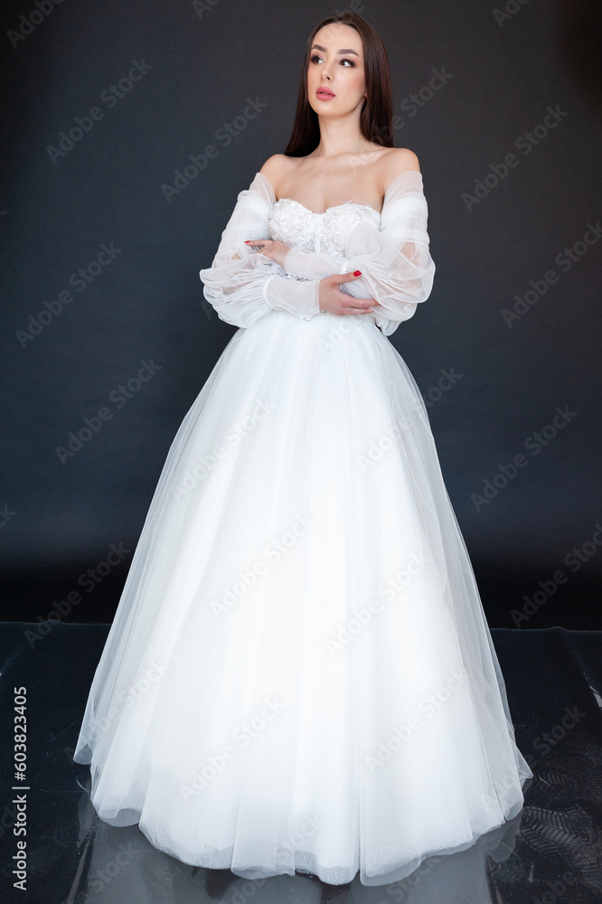 Beautiful bride in wedding dress on black background Beautiful bride in wedding dress on black background
