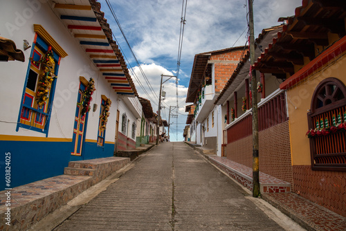 Streets of a town in Colombia, where you can see people walking through colored houses. Town in the mountains of Latin America. © Rafael Prendes