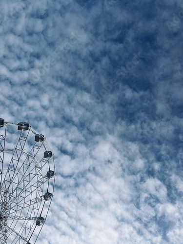 white Ferris wheel construction in the cloudy sky  photo