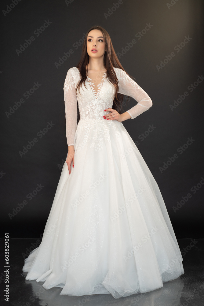 Beautiful fashion bride in wedding dress posing ob black background Beautiful fashion bride in wedding dress posing ob black background