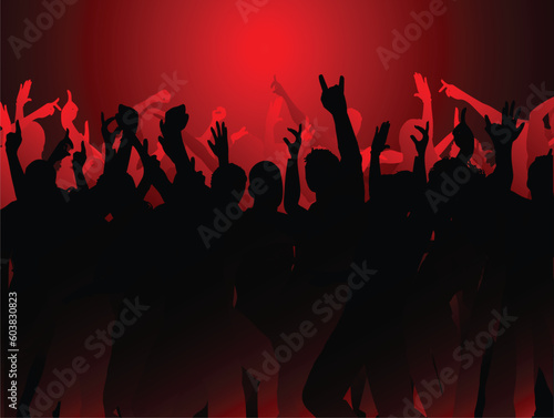 Silhouettes of an audience with their arms raised
