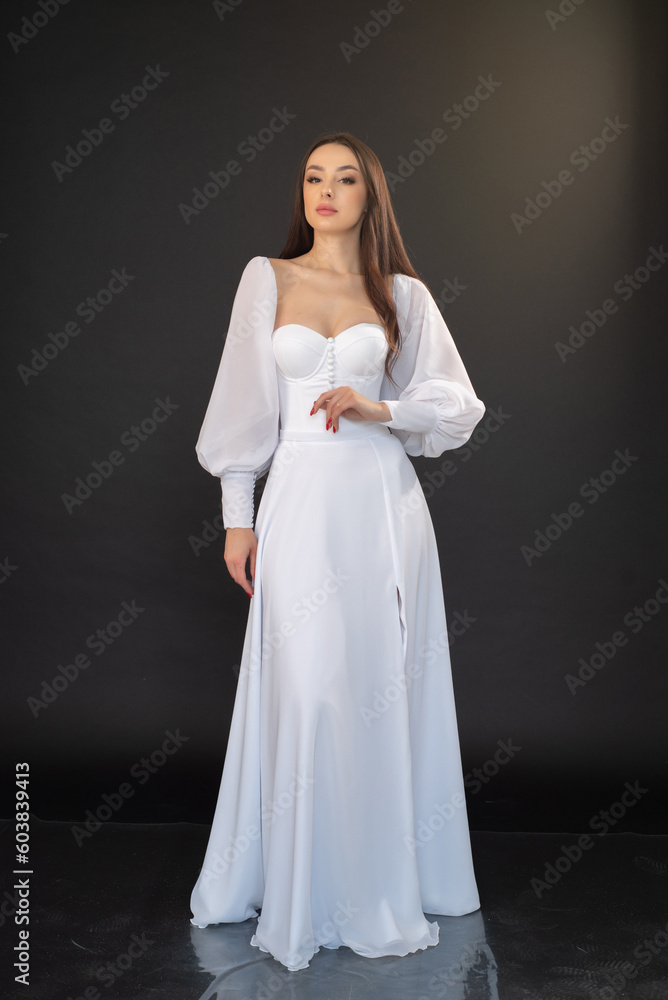 Stylish beautiful woman bride in wedding dress on black background Stylish beautiful woman bride in wedding dress on black background
