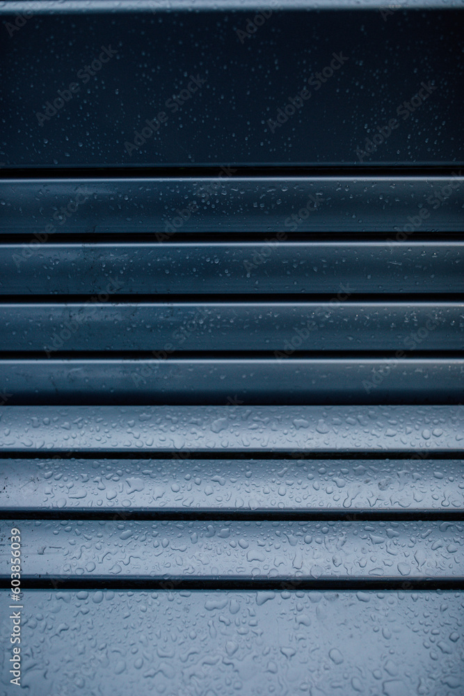 abstract gradient close up of rain on blue metallic bench with lines abstract gradient close up of rain on blue metallic bench with lines