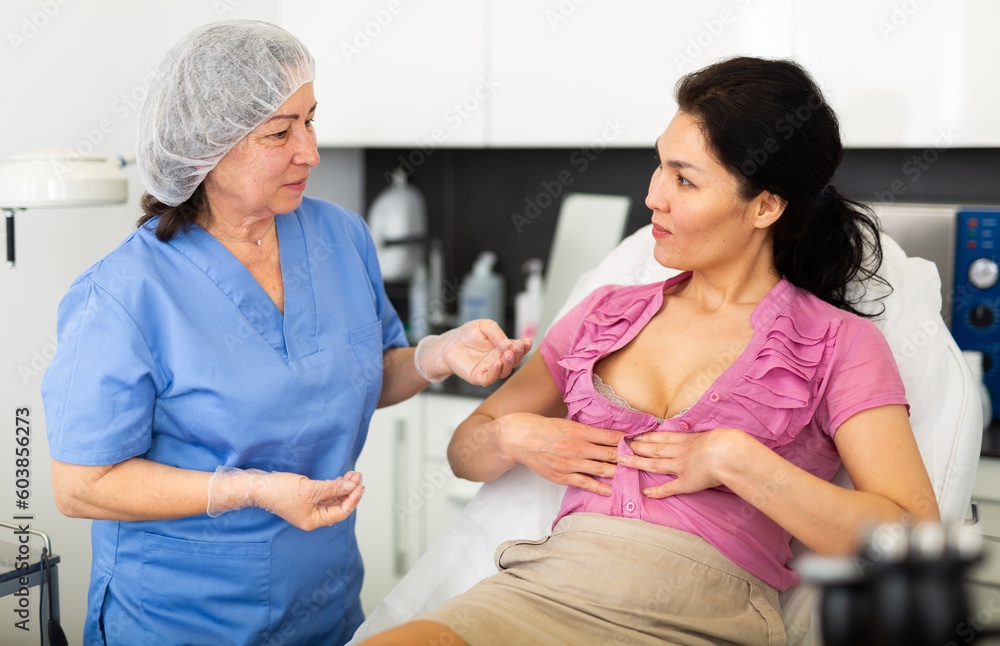 Fototapeta premium Cosmetologist planning upcoming treatments for female patient