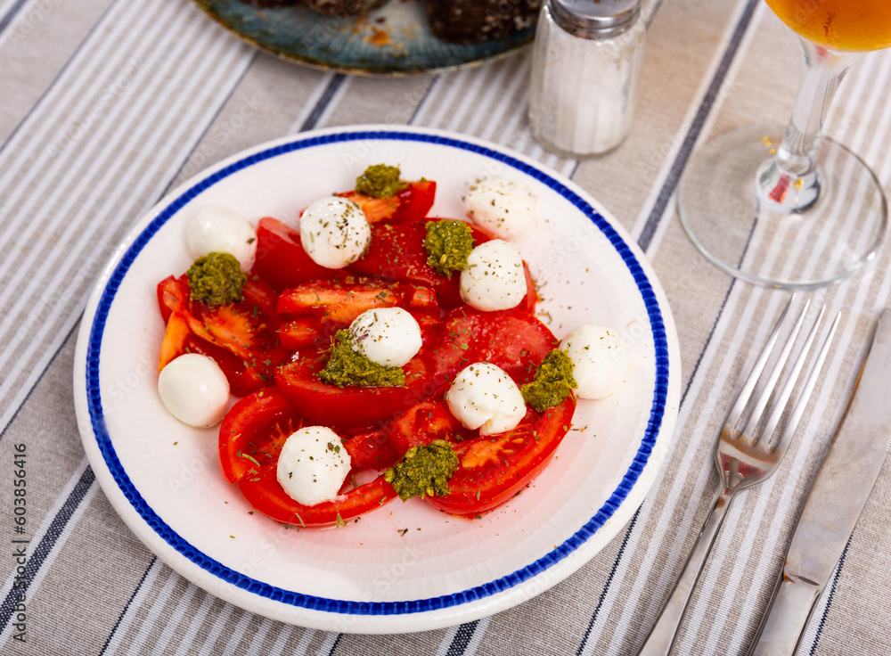 Traditional appetizer of Italian cuisine is Caprese, made from tomatoes, mozzarella, pesto sauce and olive oil