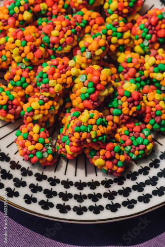colorful clusters of candy on patterned black and white plate