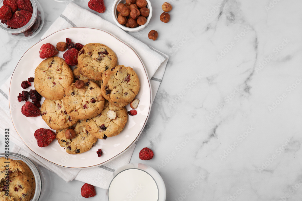 Cookies with freeze dried fruits, milk and nuts on white marble table, flat lay. Space for text Cookies with freeze dried fruits, milk and nuts on white marble table, flat lay. Space for text