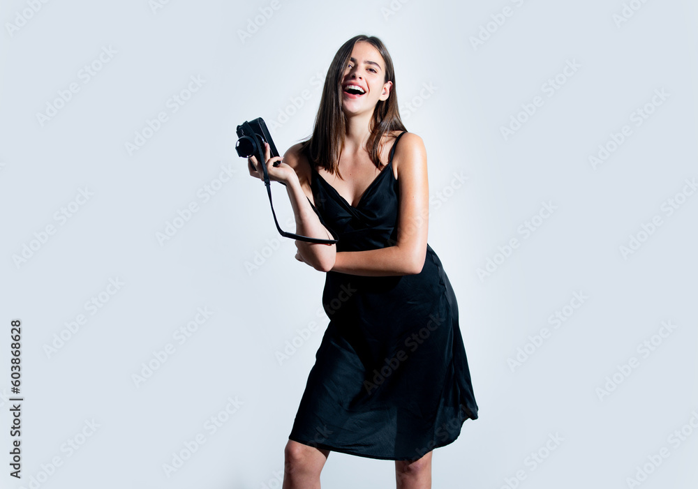 Photographer young woman, fashion model holding camera. Sexy girl using a professional camera. Photographer in white studio. Photographer young woman, fashion model holding camera. Sexy girl using a professional camera. Photographer in white studio.