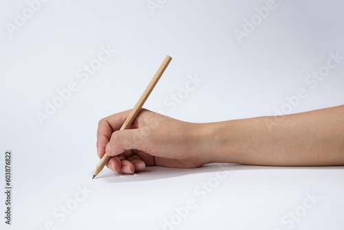 Hand holding a pencil isolated on white background