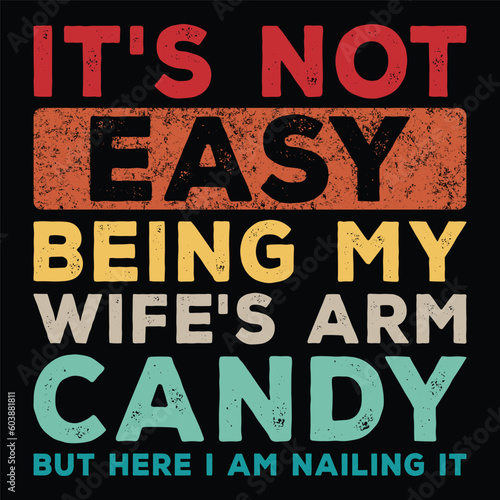 It's Not Easy Being My Wife's Arm Candy but Here I Am Nailing It t-shirt design.