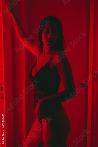 latin woman with lingerie at home, red light, artistic photo