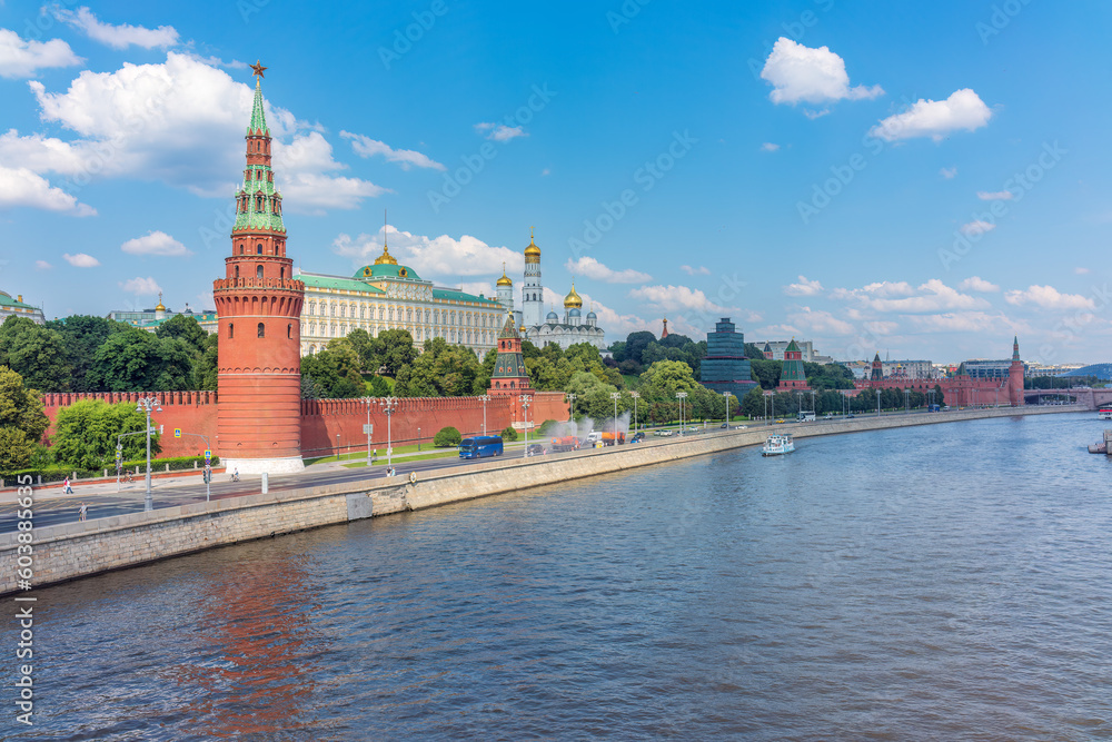 View of Kremlin with Vodovzvodnaya tower, Grand Kremlin Palace from repaired Bolshoy Kamenny Bridgein Moscow city on sunny summer day View of Kremlin with Vodovzvodnaya tower, Grand Kremlin Palace from repaired Bolshoy Kamenny Bridgein Moscow city on sunny summer day