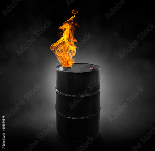 Black oil barrel with flames, on black background with smoke