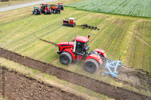 large agricultural machine cultivates the land. The view from the top. Plowing land for planting crops. photos from the bird s eye view with quadcopter