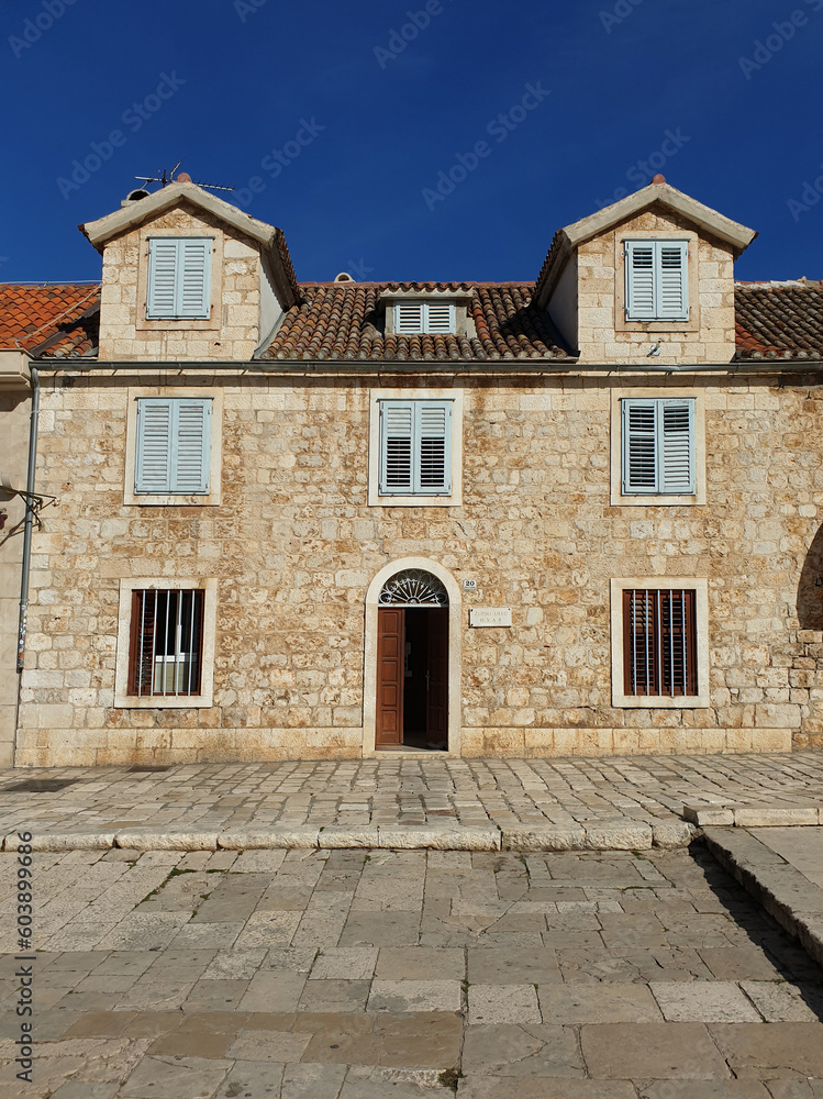historical building with stone wall located in main town square at Hvar, Croatia