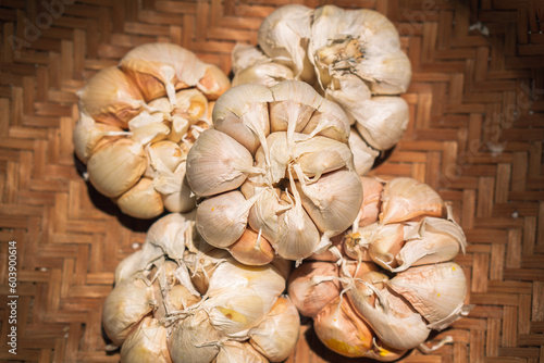 Close up garlic on rattan basket background. Garlic on wicker basket background
