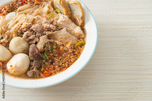 noodles with pork and meatballs in spicy soup